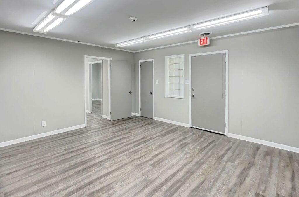 Right Space employee showcasing small office spaces for rent in Greystone, AL, equipped with modern amenities.