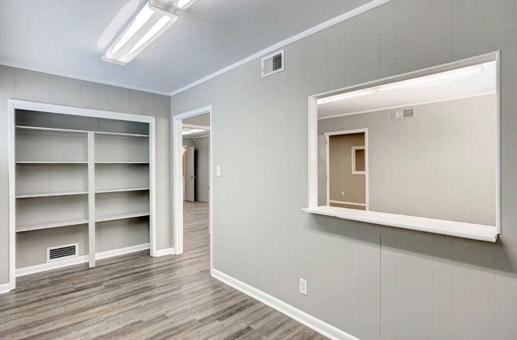 A Right Space team member showcasing a private office in North Shelby, AL, designed with modern furniture and high-tech amenities for productivity.