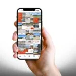 A hand holding a phone with several social posts about commercial listings on it.